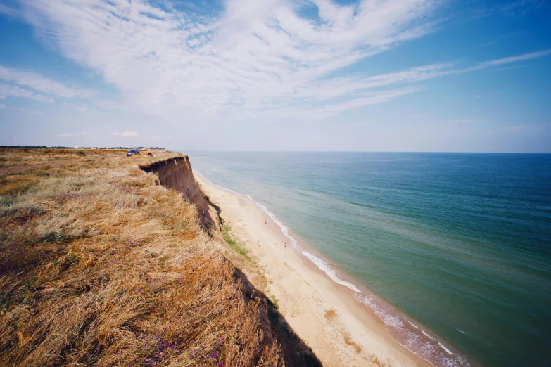 a view of a beach from the top of a cliff, by Adam Marczyński, sand dunes, profile image, ukraine. photography, conde nast traveler photo