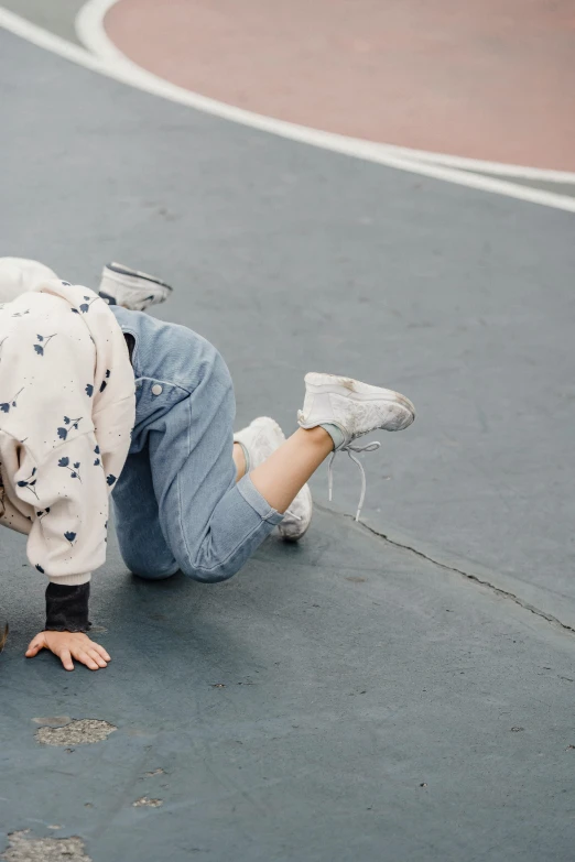 a person laying on the ground with a skateboard, by Nina Hamnett, trending on pexels, kawaii playful pose of a dancer, freaking out, wearing a track suit, spilled milk