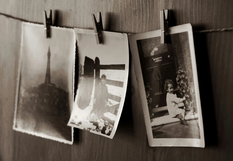 an old photo hanging on a clothes line, a black and white photo, by Lucia Peka, unsplash, old kitchen backdrop, photos of family on wall, photo from 1940s, scratches on photo