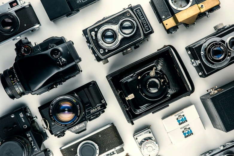 a group of cameras sitting on top of a table, art photography, grid of styles, rolleiflex, computer wallpaper, medium format