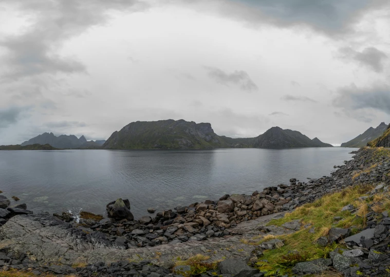 a large body of water with mountains in the background, by Roar Kjernstad, hurufiyya, 3 6 0 picture, fan favorite, panoramic, gray