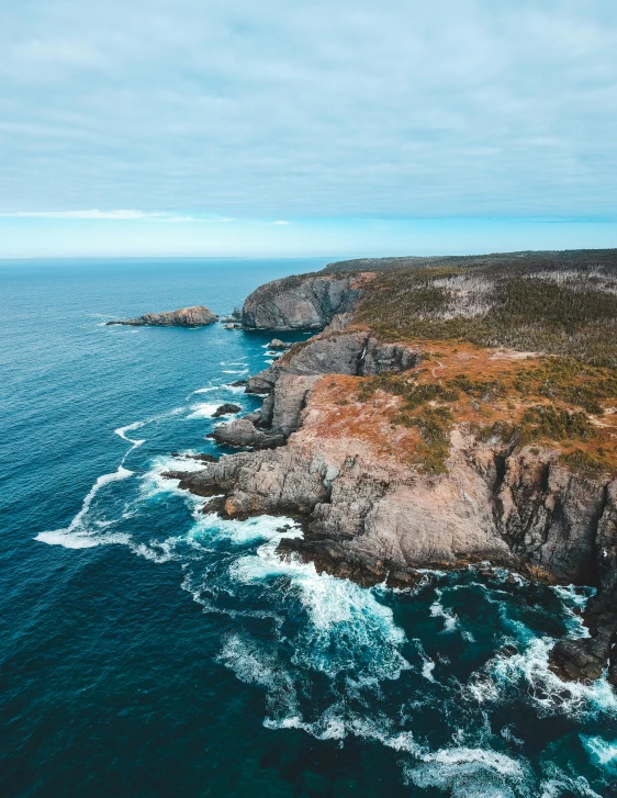 a large body of water next to a cliff, by Jessie Algie, pexels contest winner, picton blue, 2 5 6 x 2 5 6 pixels, aerial footage, coastal cliffs