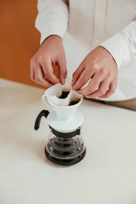 a person is preparing a cup of coffee, vlop, highly upvoted, medium height, short spout