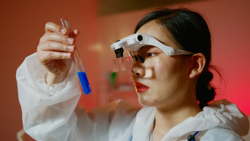 a woman in a lab coat holding a test tube, a portrait, inspired by Mei Qing, unsplash, process art, sleek oled blue visor for eyes, colour photograph, a young asian woman, handling laboratory equipment