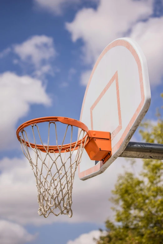 a close up of a basketball hoop with a blue sky in the background, a park, carson ellis, cinematic shot ar 9:16 -n 6 -g, medium portrait