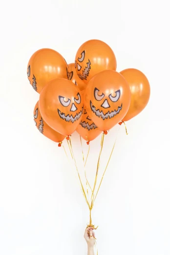 a person holding a bunch of orange balloons, with haunted eyes, silver, with gold teeth, full product shot