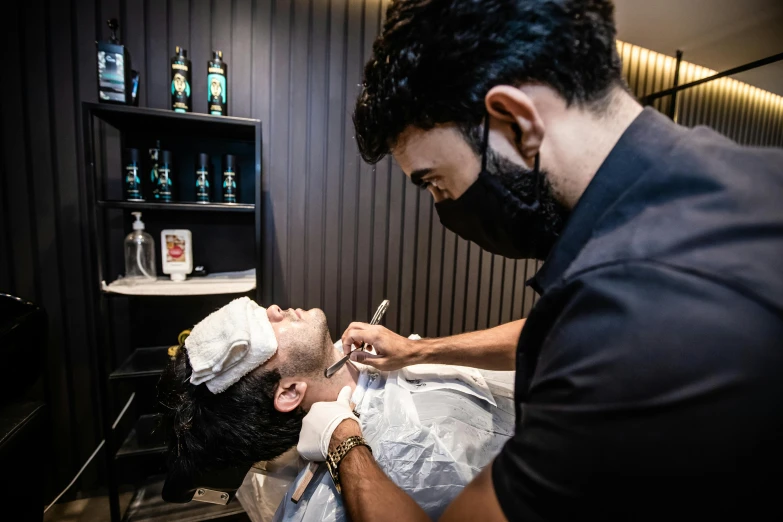 a man getting his hair cut at a barber shop, by Kanbun Master, pexels contest winner, hyperrealism, photoshoot for skincare brand, thumbnail, middle eastern skin, fully body photo