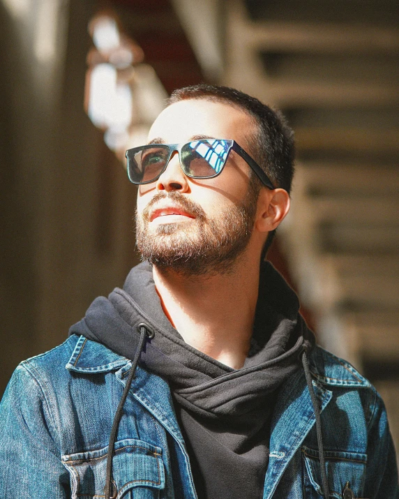 a man wearing sunglasses and a denim jacket, inspired by Germán Londoño, trending on reddit, lgbtq, attractive photo, digital photo, proud looking away