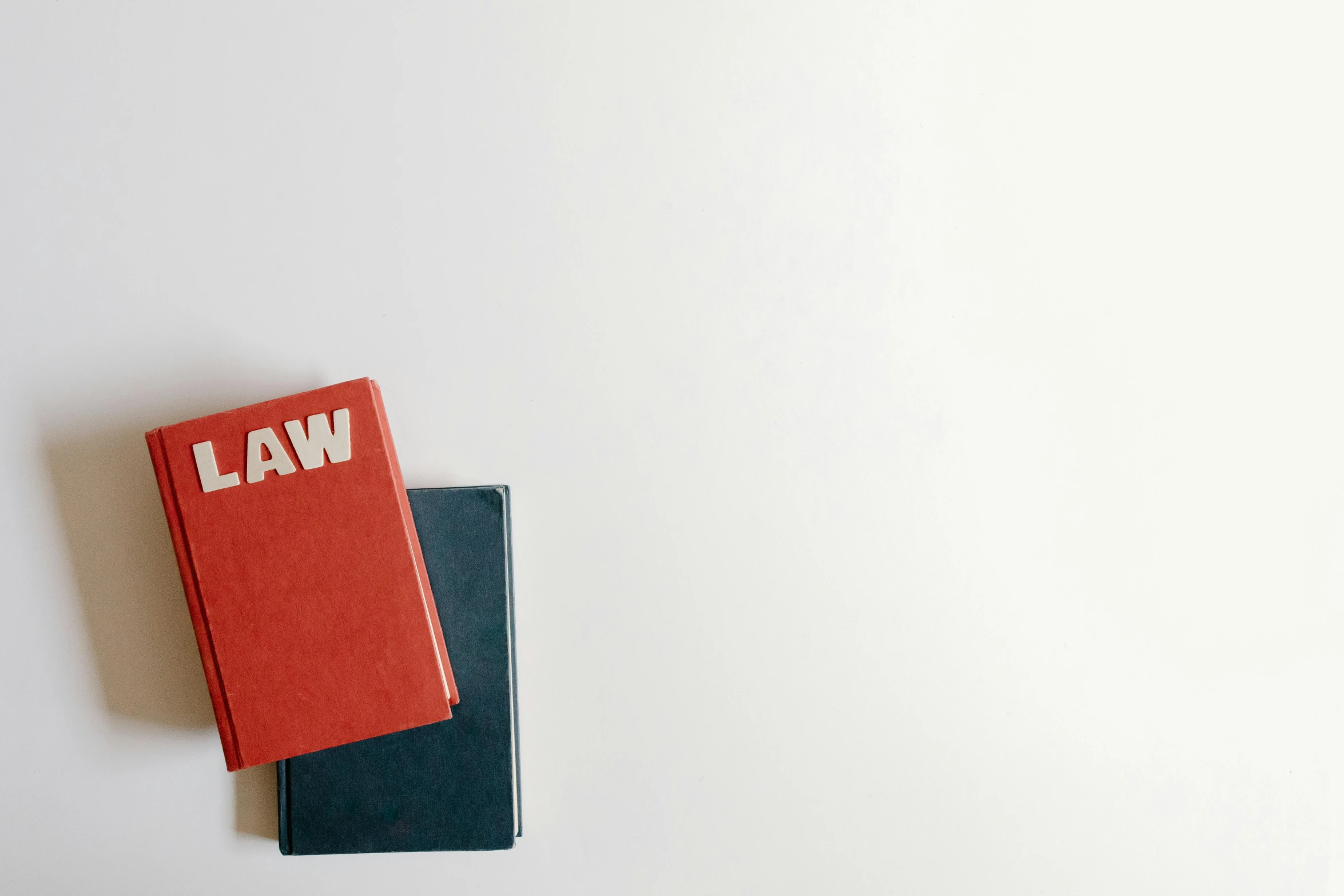 a couple of books sitting on top of each other, an album cover, unsplash, minimalism, law - alligned, background image, lawyer, notebook
