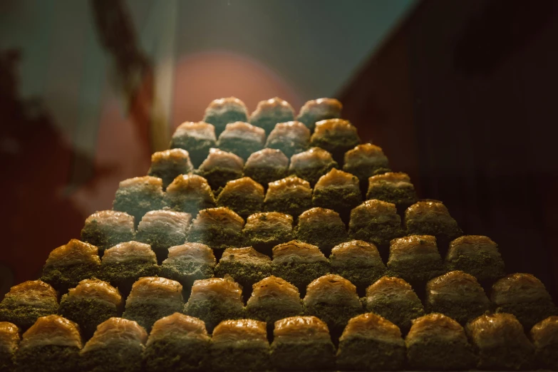 a pyramid of food sitting on top of a counter, a tilt shift photo, inspired by Elsa Bleda, unsplash, sexy sesame seed buns, in persian temple wet night, profile image, medium format