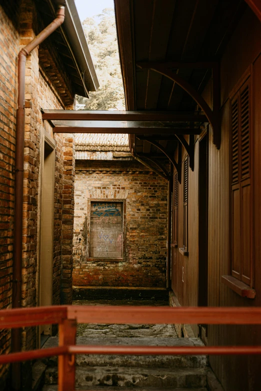 a set of stairs leading up to a brick building, by Jan Tengnagel, unsplash, australian tonalism, courtyard walkway, peaked wooden roofs, in savannah, inside of a cabin