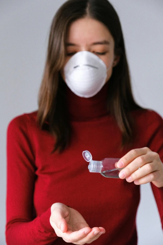 a woman in a red shirt holding a pair of scissors, by Adam Marczyński, shutterstock, nebulizer equipment, wearing turtleneck, white mask, avatar image