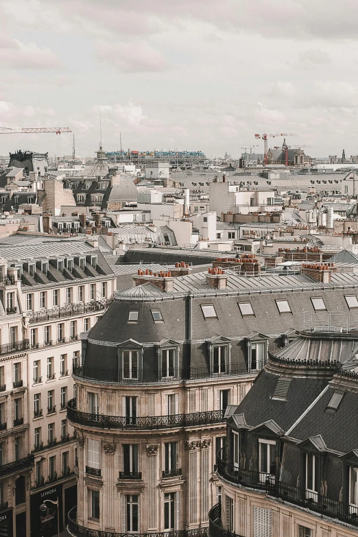 a view of a city from the top of a building, pexels contest winner, paris school, rounded roof, low quality photo, grey, a quaint