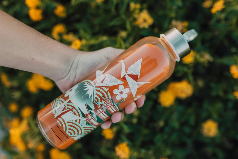 a person holding a bottle of hot sauce, inspired by Kanō Tan'yū, pexels contest winner, art nouveau, plumeria, on a sunny day, glass bottle, profile image