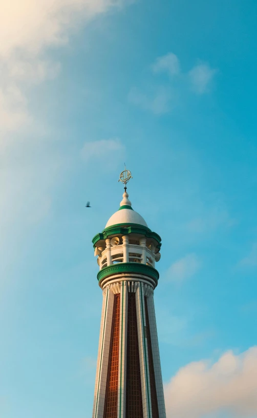 a tall tower with a clock on top of it, by Jan Tengnagel, unsplash, art nouveau, south jakarta, seaside, mosque, low quality photo