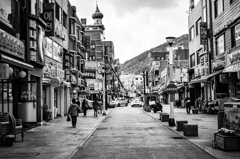 a black and white photo of a city street, by Simon Gaon, unsplash, mingei, traditional korean city, street printed poster, seaside, tehran
