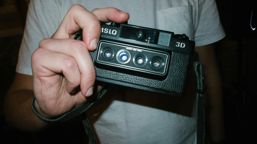 a close up of a person holding a camera, inspired by Elsa Bleda, black 3 d cuboid device, iso 50, retro 3 d, ansel ]