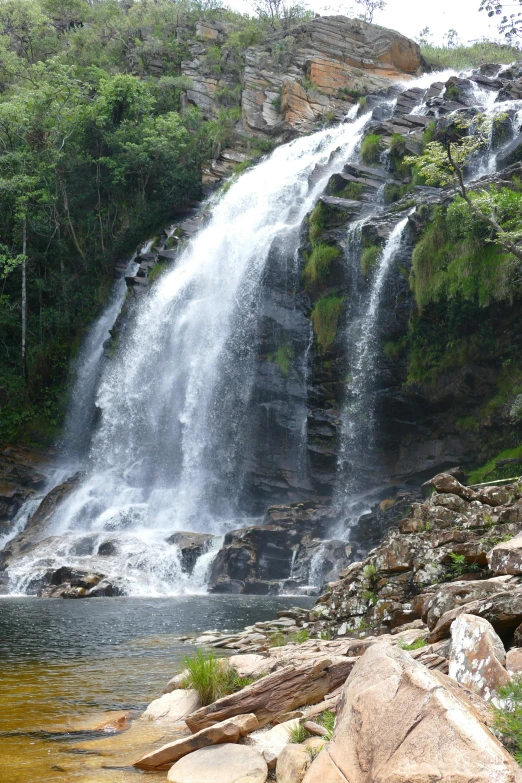 a waterfall in the middle of a lush green forest, sao paulo, fishing, mountainous jungle setting, front facing