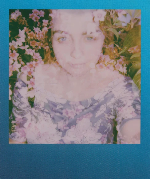 a polaroid picture of a woman with flowers in her hair, pexels contest winner, holography, blue border, sophia lillis, center of picture, slightly blurred