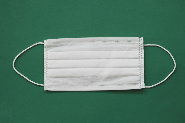 a white face mask on a green background, pexels, sōsaku hanga, surgical supplies, square face, white skirt, white borders