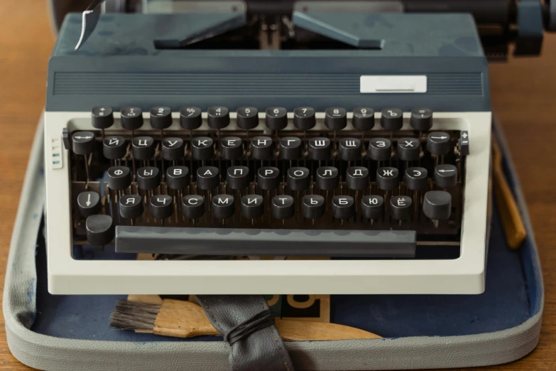 an old typewriter sitting on top of a wooden table, by Carey Morris, unsplash, private press, background 1970s office, fully frontal view, replica model, 1972 soviet