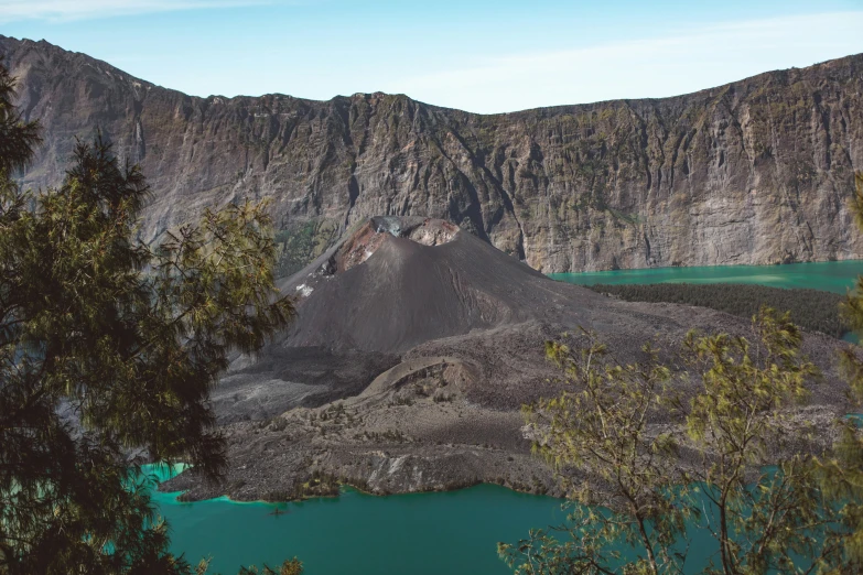 a mountain with a lake in the middle of it, a colorized photo, by Kogan Gengei, pexels contest winner, sumatraism, crater, eucalyptus, turqouise, festivals