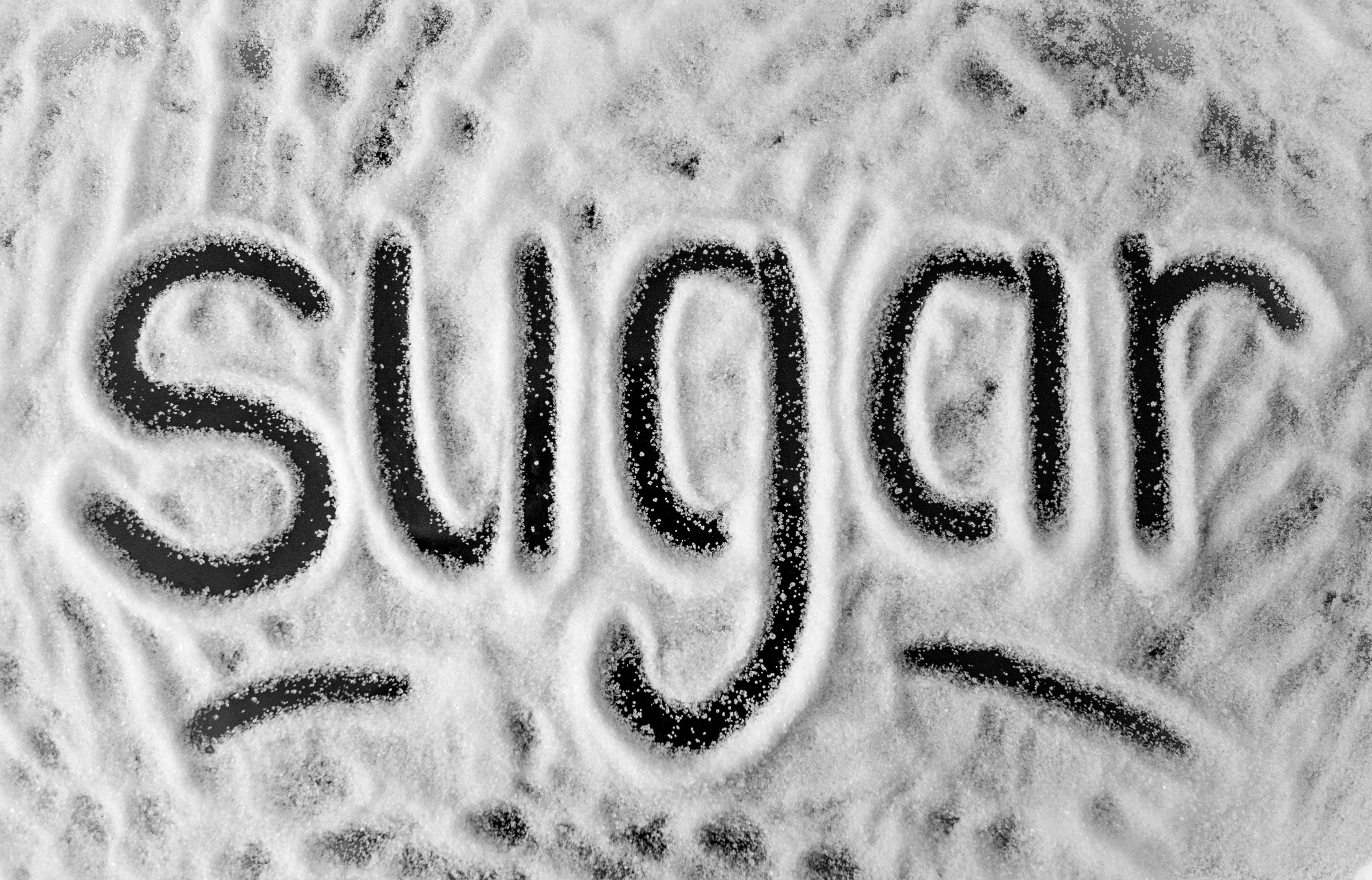 a sugar ball with the word sugar written on it, an engraving, by Silvia Pelissero, pixabay, graffiti, grainy black and white footage, background image, food art, winter