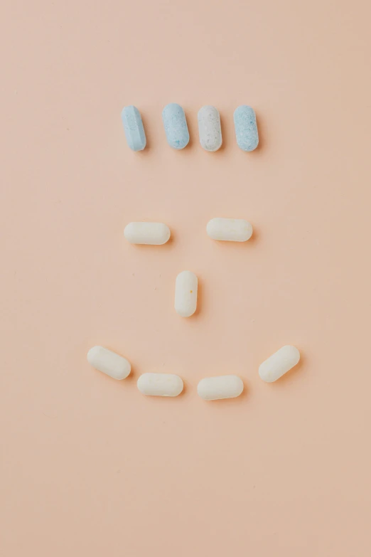 pills arranged in the shape of a smiley face, reddit, antipodeans, soft blue and pink tints, victoria siemer, happy robot, medium - shot