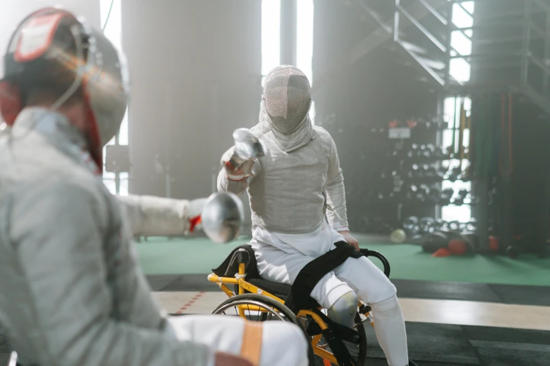 a couple of men standing next to each other on a field, pexels contest winner, process art, fencing, sitting in a wheelchair, sparring, indoor