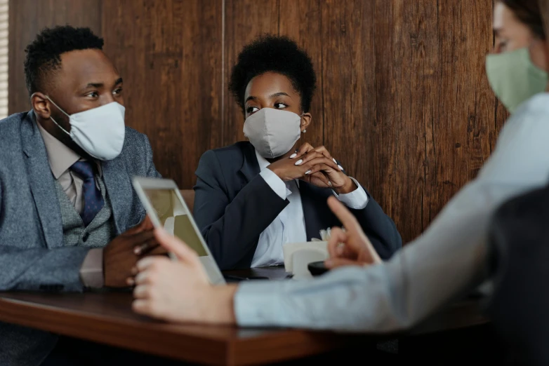 a group of people sitting around a table with masks on, trending on pexels, toxic air, ashteroth, thumbnail, background image