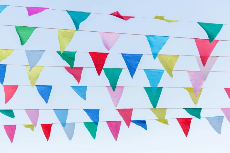 a bunch of colorful flags hanging from a wire, by Helen Stevenson, unsplash, happening, triangle, ilustration, taken from the high street, sky blue