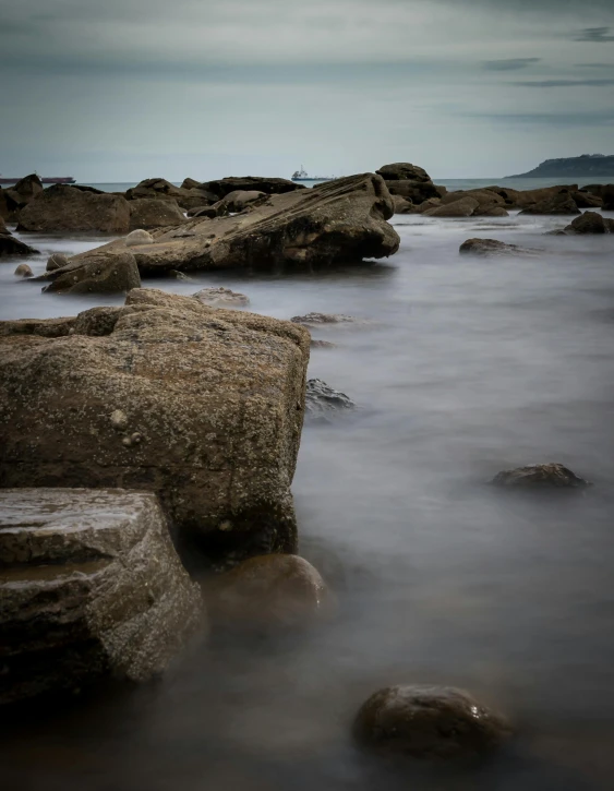 a group of rocks sitting on top of a body of water, manly, spooky photo, today\'s featured photograph 4k, medium format