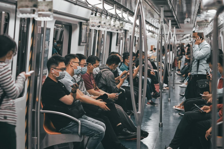 a group of people sitting on a subway train, jia ruan, pandemic, technologies, fan favorite