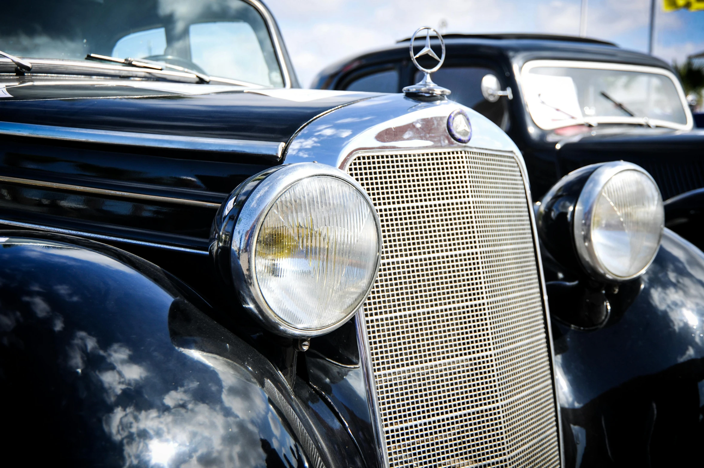 a couple of old cars parked next to each other, by David Simpson, pixabay, photorealism, focus on facial detail, square, mercedez benz, sparkling in the sunlight