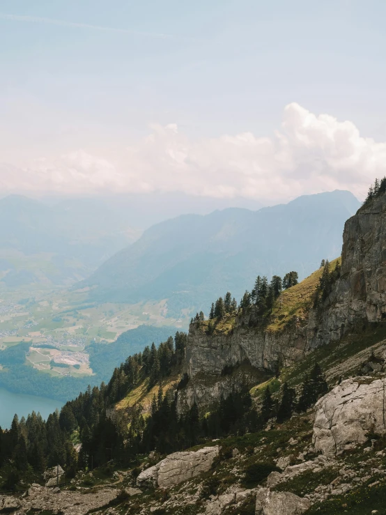 a group of people standing on top of a mountain, by Johannes Voss, pexels contest winner, overlooking a valley with trees, limestone, switzerland, 4 k cinematic panoramic view