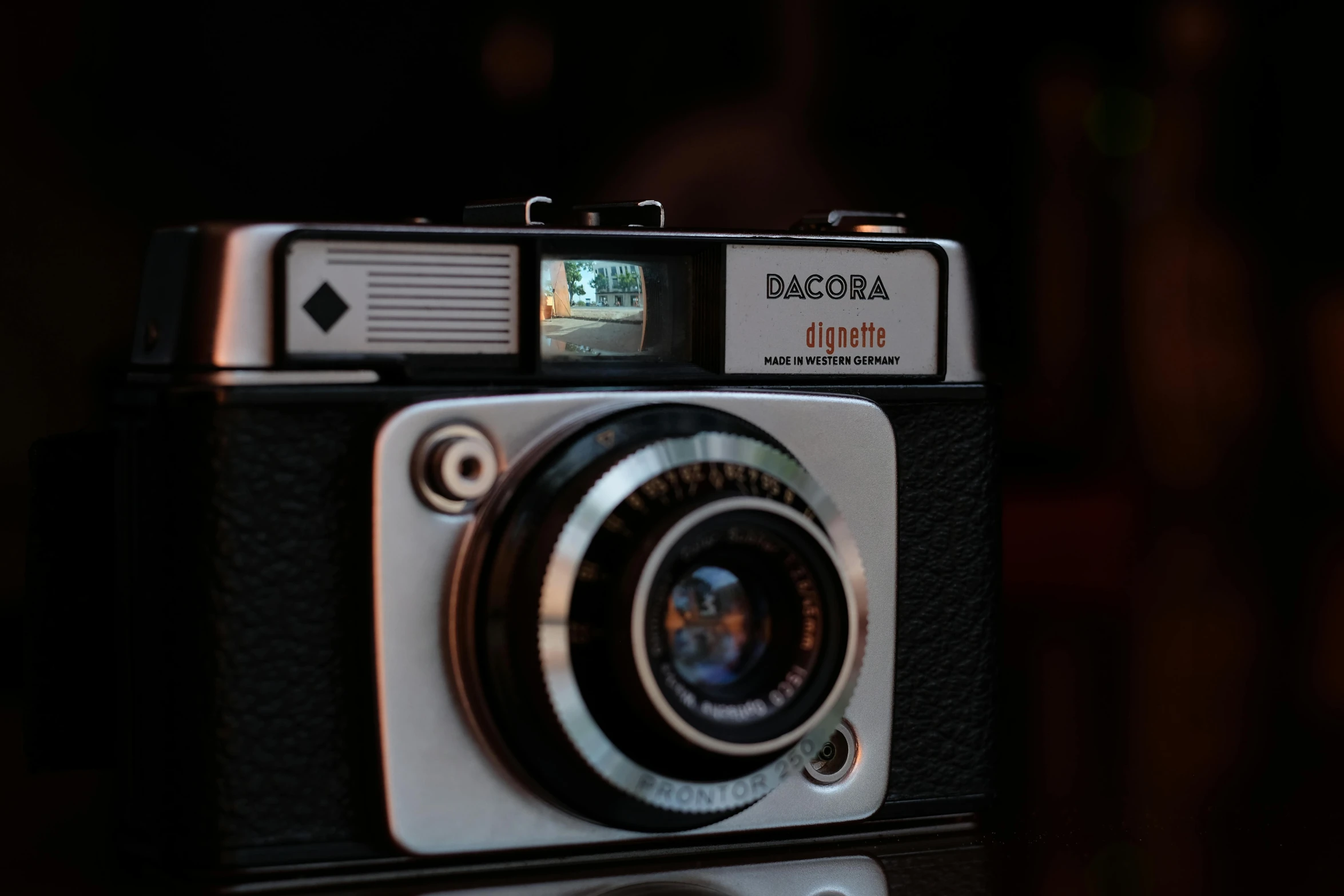 a close up of a camera on a table, by Dan Frazier, unsplash contest winner, dada, 1 9 7 0 colour photography, bokeh. chrome accents, corona render, circa 1970