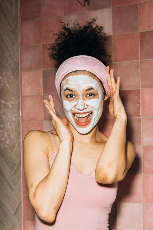 a woman with a face mask in a bathroom, by Julia Pishtar, trending on pexels, amused facial expression, pink skin, face on head shot, oriental face