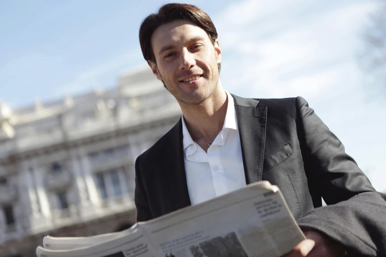 a man holding a newspaper in front of a building, professional picture, madrid, avatar image