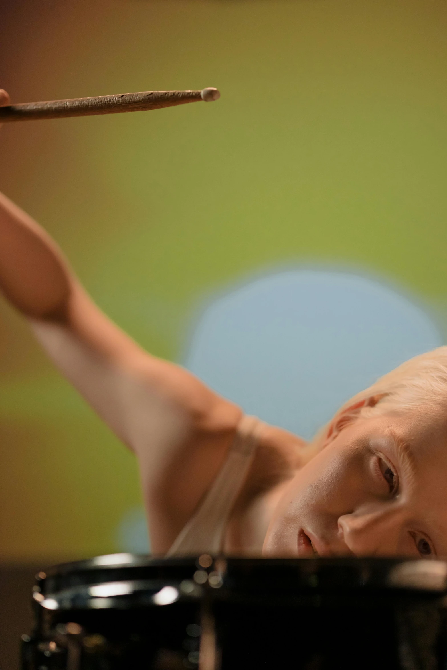 a man that is sitting in front of a drum, inspired by Agnes Lawrence Pelton, video art, girl with short white hair, close up angle, female dancer, portrait tilda swinton