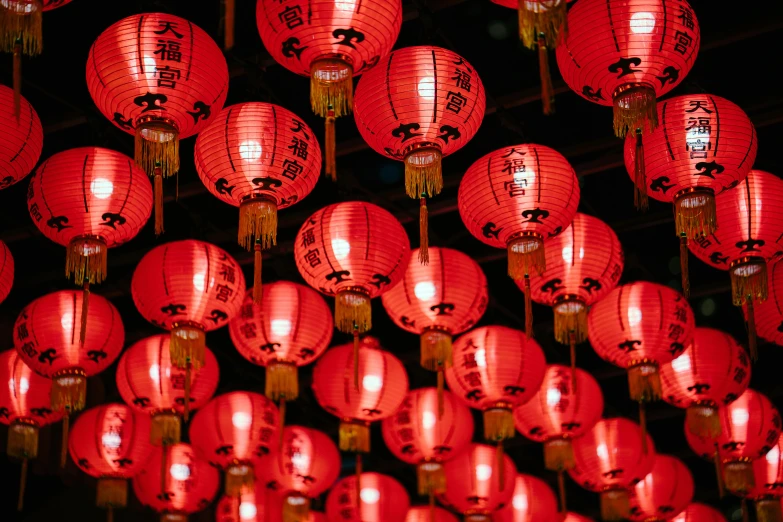 a bunch of red lanterns hanging from the ceiling, at night, looking towards camera, language, in style of ruan jia