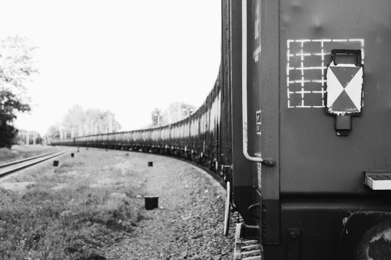 a black and white photo of a train, a black and white photo, unsplash, surrealism, fineartamerica, view from the side”, repeating 3 5 mm photography, yard