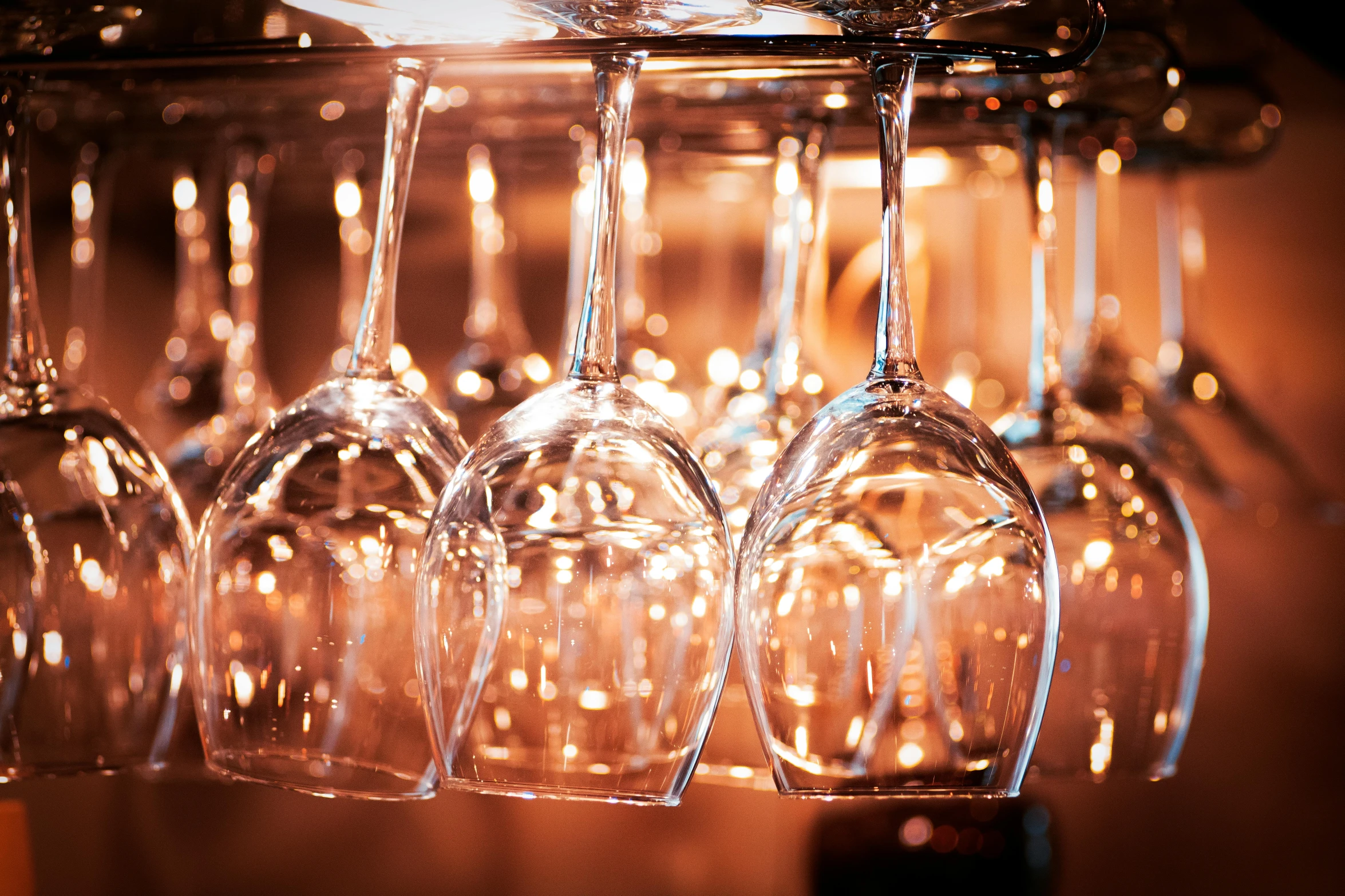 a bunch of wine glasses hanging from a rack, pexels, happening, crystal lighting, fan favorite, profile image, slightly tanned