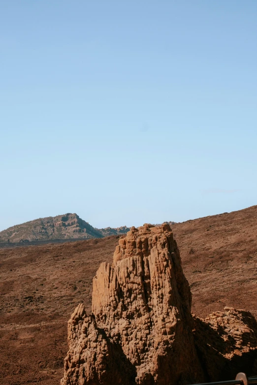 a large rock in the middle of a desert, by Lee Loughridge, les nabis, towering high up over your view, volcanic, seen from a distance, sparse detail