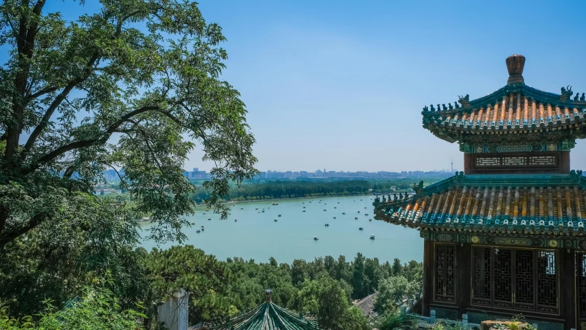 a pagoda sitting on top of a lush green hillside, inspired by An Zhengwen, pexels contest winner, art nouveau, lake in the distance, peking opera, city buildings on top of trees, 2 0 2 2 photo