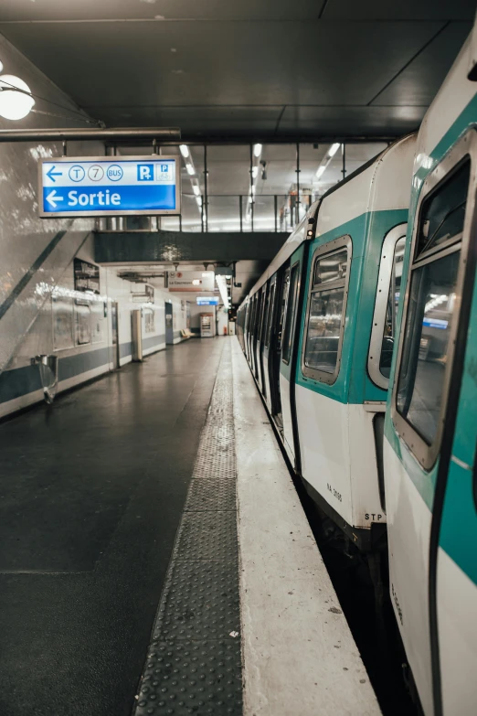 a train pulling into a train station next to a platform, by Raphaël Collin, instagram, white and teal garment, inside of a metro train, no people, taken in the late 2000s