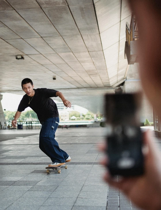 a man riding a skateboard while holding a cell phone, a picture, by Fei Danxu, camera footage, portait image