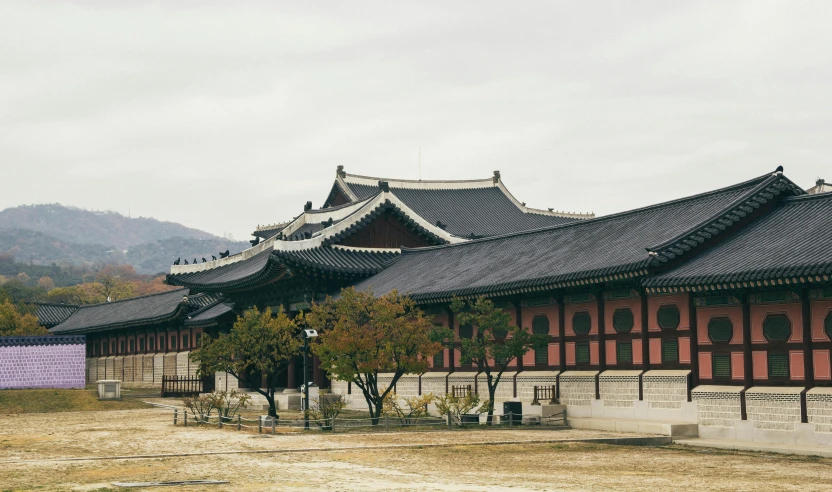 a group of buildings sitting on top of a dirt field, inspired by Kim Hong-do, trending on unsplash, cloisonnism, royal palace interior, square, exterior view, grey