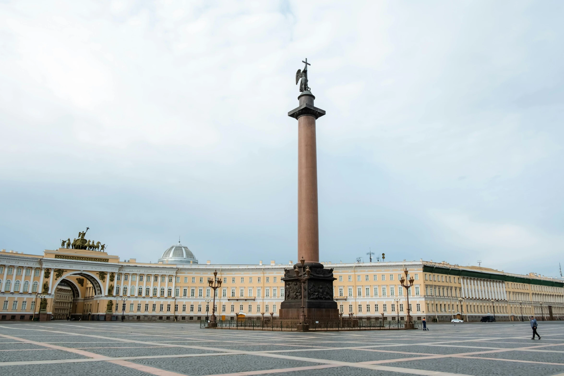 a statue in the middle of a square with a building in the background, inspired by Illarion Pryanishnikov, pexels contest winner, neoclassicism, pillar, panorama view, square, brown