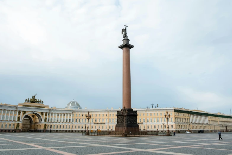 a statue in the middle of a square with a building in the background, inspired by Illarion Pryanishnikov, pexels contest winner, neoclassicism, pillar, panorama view, square, brown