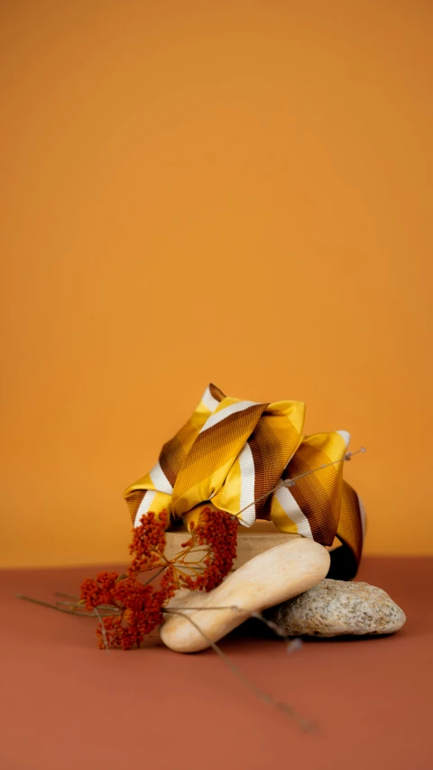 a bunch of bananas sitting on top of a table, an abstract sculpture, by Jessie Algie, pexels contest winner, orange rocks, golden ribbons, studio packshot, frank gehry architecture
